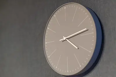 a clock that is on the side of a wall at \u30c8\u30eb\u30b3\u30d6\u30eb\u30fc\u30d3\u30eb in Tokyo