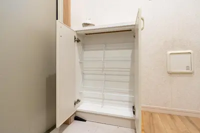 a closet with white shelves in a room at City Oasis in Tokyo