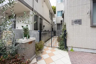 a statue of a cat sitting on a box in front of a building at City Oasis in Tokyo