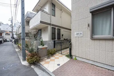a house on a street next to a sidewalk at City Oasis in Tokyo