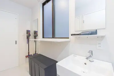 a white bathroom with a sink and a window at Pufuka Hikifune \u3077\u3075\u304b\u66f3\u821f in Tokyo
