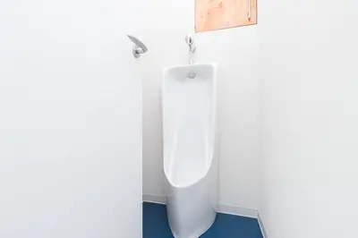 a bathroom with a white urinal in a room at Pufuka Hikifune \u3077\u3075\u304b\u66f3\u821f in Tokyo