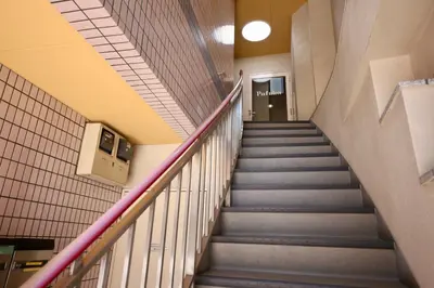 a staircase in a hallway in a building at Pufuka Hikifune \u3077\u3075\u304b\u66f3\u821f in Tokyo