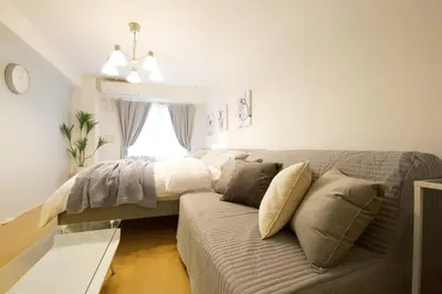 a living room with a couch and a bed at Generous Forest 201 in Tokyo