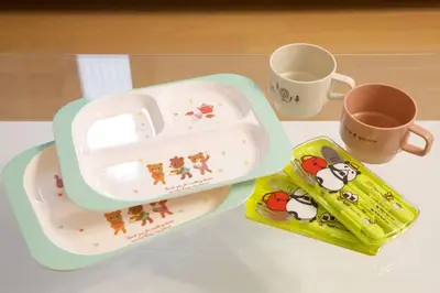 a table with a hello kitty lunch box and a cup at Generous Forest 201 in Tokyo