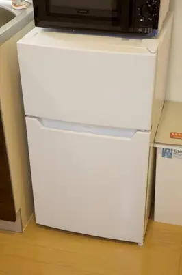 a white refrigerator with a microwave on top of it at Generous Forest 201 in Tokyo