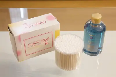a bottle of calcium oil next to a box of cups at Generous Forest 201 in Tokyo