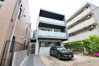 a black car parked in front of a building at Generous Forest 201 in Tokyo