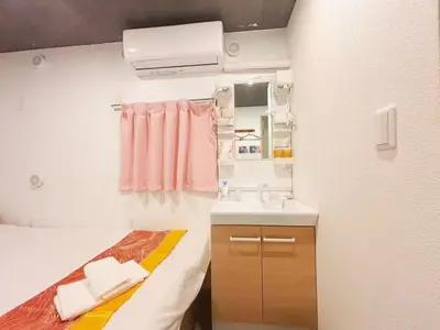 a small bathroom with a bed and a sink at Hananogo Ikebukuro - Vacation STAY 16071v in Tokyo