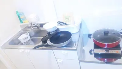 a kitchen counter with a sink with pots and pans at Hananogo Ikebukuro - Vacation STAY 16071v in Tokyo