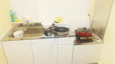a kitchen counter with two pans and a sink at Hananogo Ikebukuro - Vacation STAY 16082v in Tokyo