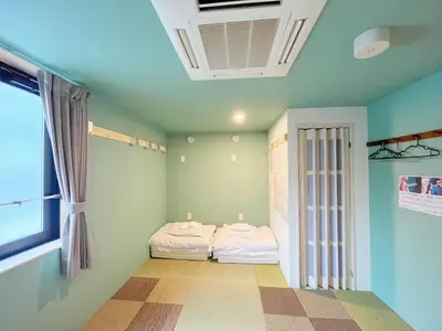 a room with two beds in a room with a window at Hananogo Ikebukuro - Vacation STAY 16116v in Tokyo