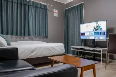 a hotel room with a bed and a tv at Livion III in Tokyo