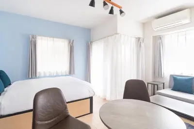 a bedroom with a bed and a table and chairs at KISETSU Omori I in Tokyo