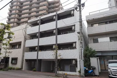 an apartment building with a car parked in front of it at KISETSU Omori I in Tokyo