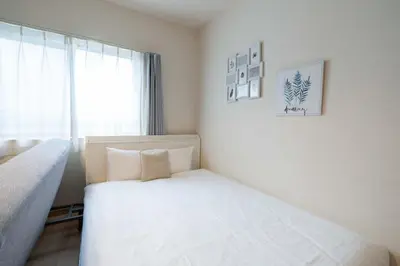a bedroom with two beds and a window at KISETSU Omori I in Tokyo
