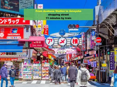 a busy street in an asian city with people crossing the street at 浅草寺3分 浅草駅6分 寝室+リビング2-4人 スカイツリービュー 駅近 成田空港&羽田空港直通 in Tokyo