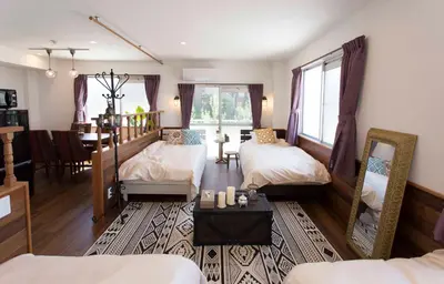 a bedroom with two beds and a dining room at \u30d1\u30eb\u30c6\u30e9\u30b9\u5bcc\u58eb\u898b in Tokyo
