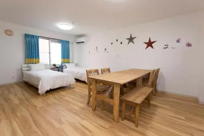 a room with a table and a bed and a table and chairs at \u30d1\u30eb\u30c6\u30e9\u30b9\u5bcc\u58eb\u898b in Tokyo