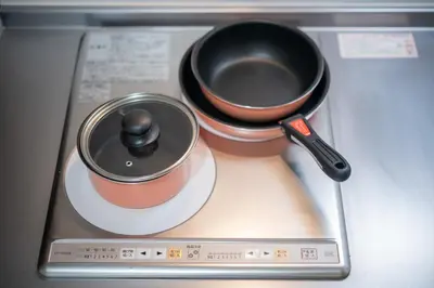 a pot and a spoon sitting on top of a stove at Ferio in Tokyo