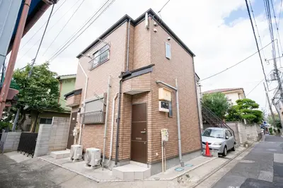 a brick building with a car parked in front of it at Ferio in Tokyo