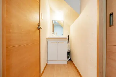 a bathroom with a white sink and a door at Ferio in Tokyo