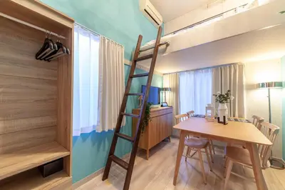 a room with a loft bed and a table and a desk at \u8981\u753a\u30b7\u30c6\u30a3\u30cf\u30a4\u30e0 in Tokyo