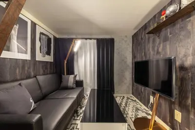 a living room with a couch and a flat screen tv at \u8981\u753a\u30b7\u30c6\u30a3\u30cf\u30a4\u30e0 in Tokyo