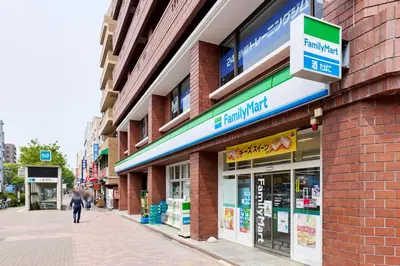 a person walking down a sidewalk in front of a store at \u8981\u753a\u30b7\u30c6\u30a3\u30cf\u30a4\u30e0 in Tokyo