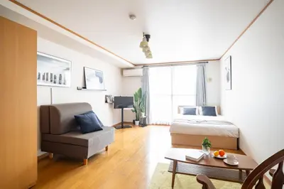 a bedroom with a bed and a chair and a table at DeLCCS\u543e\u59bb\u6a4bIII in Tokyo