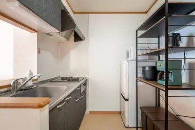 a kitchen with a sink and a refrigerator at DeLCCS\u543e\u59bb\u6a4bIII in Tokyo