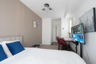 a bedroom with a bed and a desk with a computer at Grande\u68ee\u4e0b in Tokyo