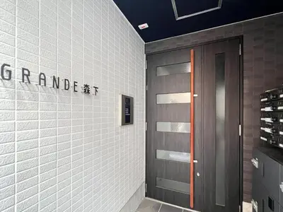 a door in a room with a white tiled wall at Grande\u68ee\u4e0b in Tokyo