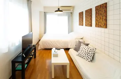 a small room with a bed and a couch at \u690d\u7530\u30cf\u30a4\u30c4 in Tokyo