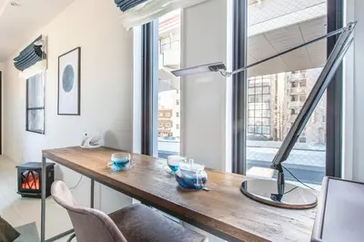 a living room with a wooden table and a fireplace at \u30ce\u30be\u30df\u30aa\u30d7\u30ec\u30df\u30a2\u660e\u5927\u524d in Tokyo