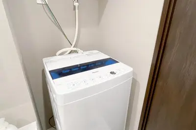 a white washer and dryer in a room at \u30ce\u30be\u30df\u30aa\u30d7\u30ec\u30df\u30a2\u660e\u5927\u524d in Tokyo