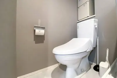 a bathroom with a white toilet in a stall at \u30ce\u30be\u30df\u30aa\u30d7\u30ec\u30df\u30a2\u660e\u5927\u524d in Tokyo