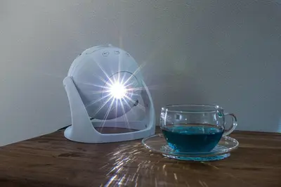 a juicer and a cup of water on a table at \u30ce\u30be\u30df\u30aa\u30d7\u30ec\u30df\u30a2\u660e\u5927\u524d in Tokyo