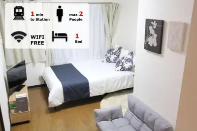 a small bedroom with a bed and a couch at LUANA NOGATA in Tokyo