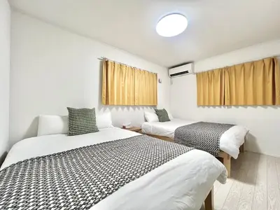 two beds in a small room with windows at Tokyo QY TT0431 in Tokyo