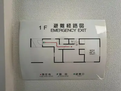 a sign for an emergency exit on a wall at Tokyo QY TT0431 in Tokyo