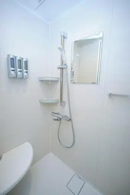a white bathroom with a shower and a toilet at Seirai Vacation Rental Hatsudai - Vacation STAY 15951v in Tokyo