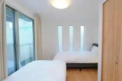 a bedroom with two beds and a window at Seirai Vacation Rental Hatsudai - Vacation STAY 15951v in Tokyo