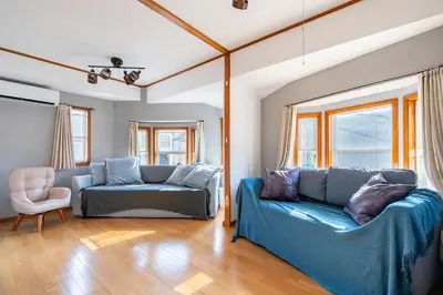 a living room with two blue couches and a chair at BISK PARK TOKYO - 4LDK&2Bath Spacious House - Easy Access to Asakusa, Skytree & Airport in Tokyo