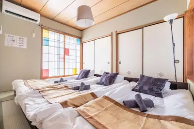 two large beds in a room with windows at BISK PARK TOKYO - 4LDK&2Bath Spacious House - Easy Access to Asakusa, Skytree & Airport in Tokyo