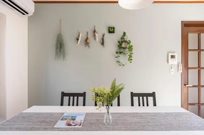 a dining room with a table with a vase of flowers at BISK PARK TOKYO - 4LDK&2Bath Spacious House - Easy Access to Asakusa, Skytree & Airport in Tokyo