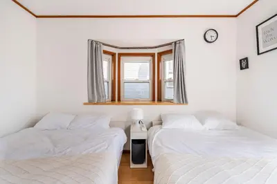 two twin beds in a room with a window at BISK PARK TOKYO - 4LDK&2Bath Spacious House - Easy Access to Asakusa, Skytree & Airport in Tokyo