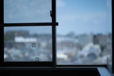 a window with a view of a city at Nishinippori Guest House -Sendagi house- , elevator , private kitchen , private bathroom in Tokyo