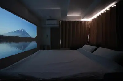 a bedroom with a bed with a view of a mountain at Nishinippori Guest House -Sendagi house- , elevator , private kitchen , private bathroom in Tokyo