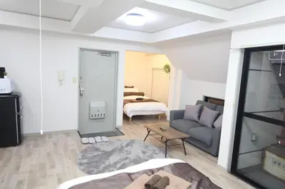 a living room with a couch and a bedroom at LUANA ARAI in Tokyo